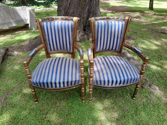 A Pair Of 20th Century French Louis XVI Styled Ornately Carved And Gilded Arm Chairs - Image 2