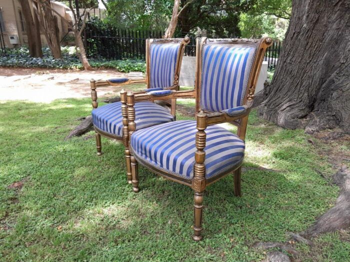 A Pair Of 20th Century French Louis XVI Styled Ornately Carved And Gilded Arm Chairs - Image 3