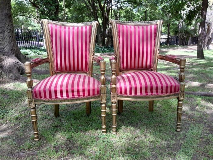 A Pair Of 20th Century French Louis XVI Styled Ornately Carved And Gilded Arm Chairs - Image 6