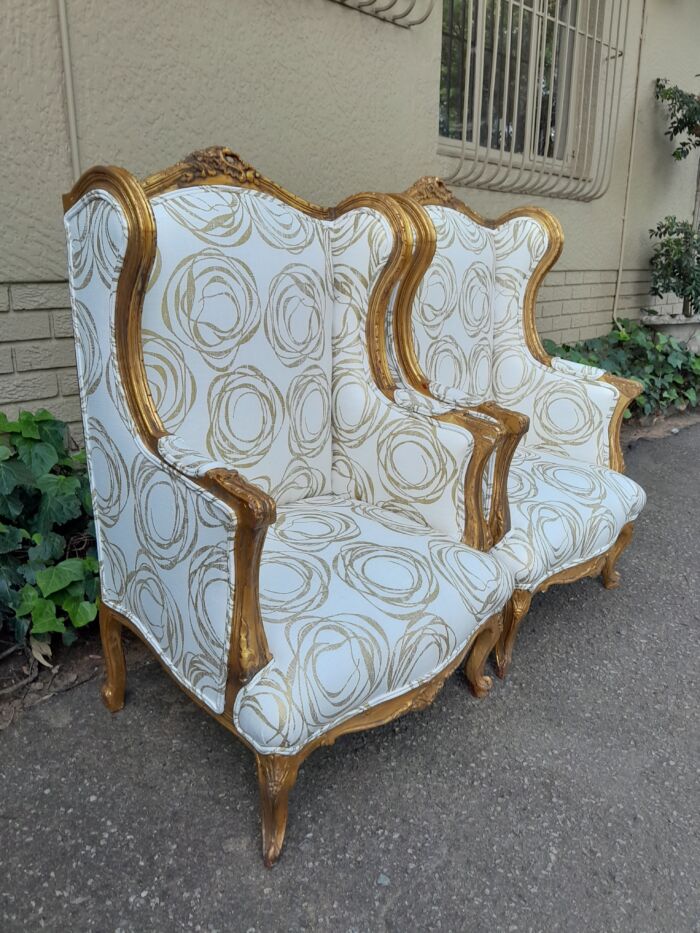 A French Style Pair of Hand Gilded Carved Wingback Chairs Upholstered in a Custom Made for The Crown Collection Cotton / Linen Fabric - Image 4