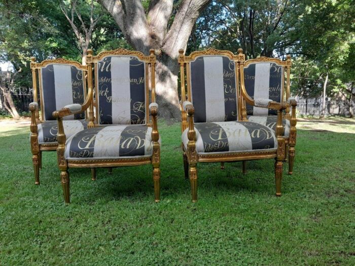 A French Style Set Of Four Ornately Carved And Gilded Armchairs In A Custom-Made Stripe And Script Linen (Also Sold As Pairs SKU 3109)