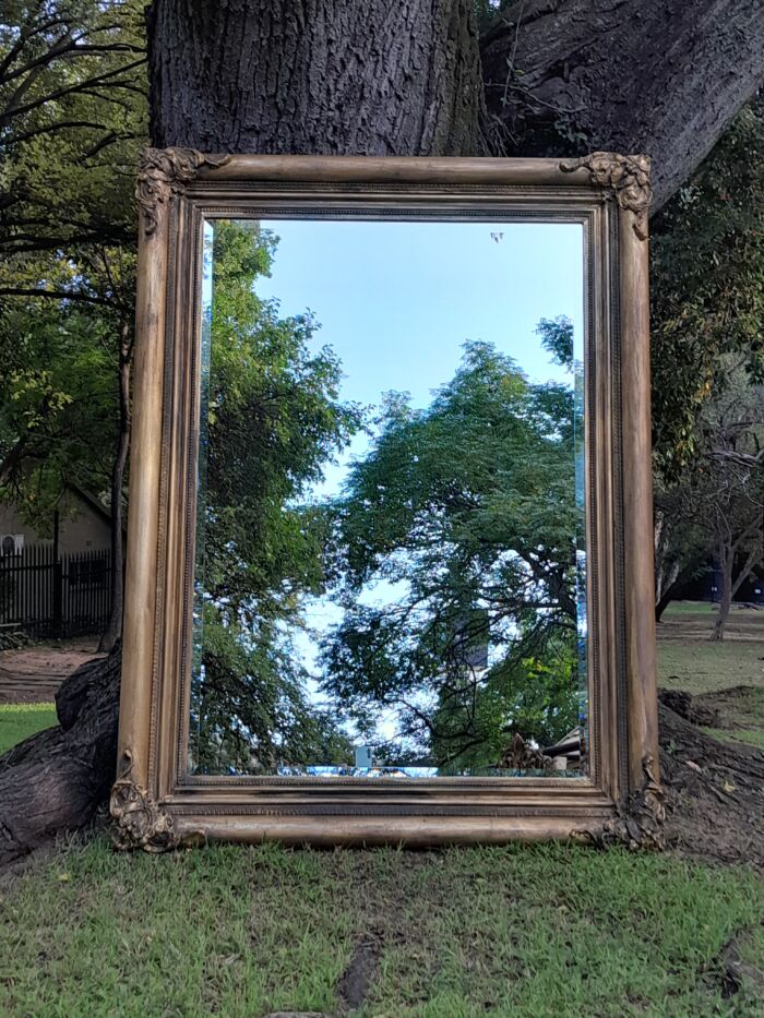 A 20th Century French Style Ornately Carved And Hand Gilded Bevelled Mirror