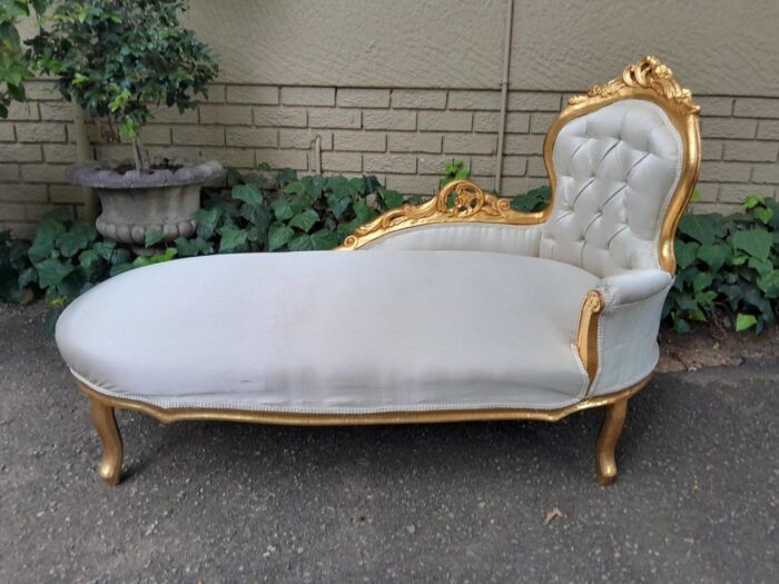 A French Ornately Carved And Gold Painted Chaise