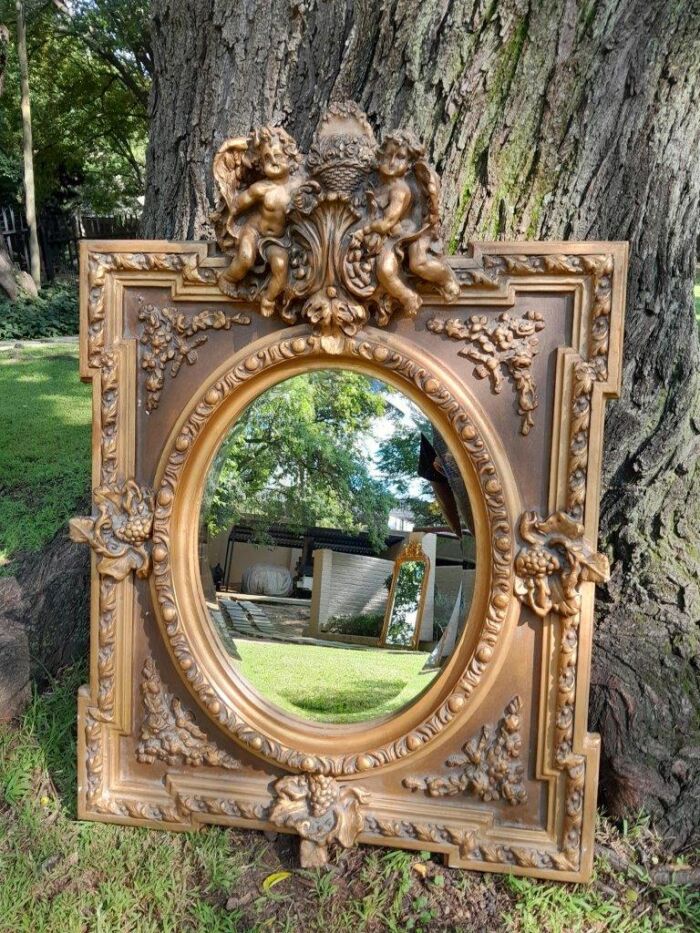 A French Rococo Style Ornately Carved and Gilded Bevelled Mirror