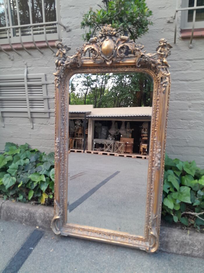 A French Style Ornately Carved and Gilded Bevelled Mirror