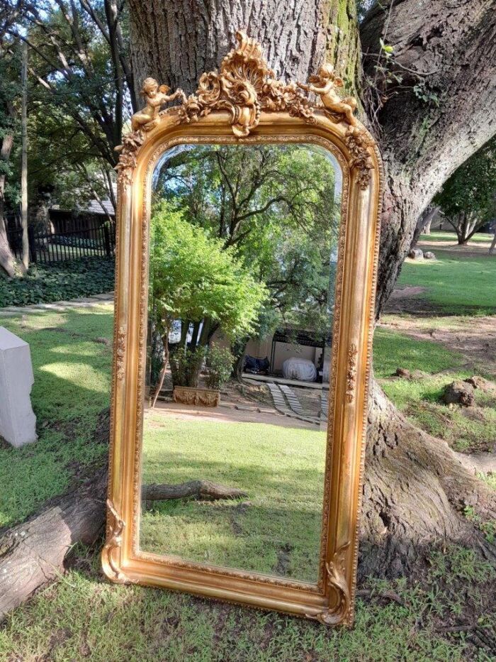 A French Style Ornately Carved and Gilded Bevelled Mirror