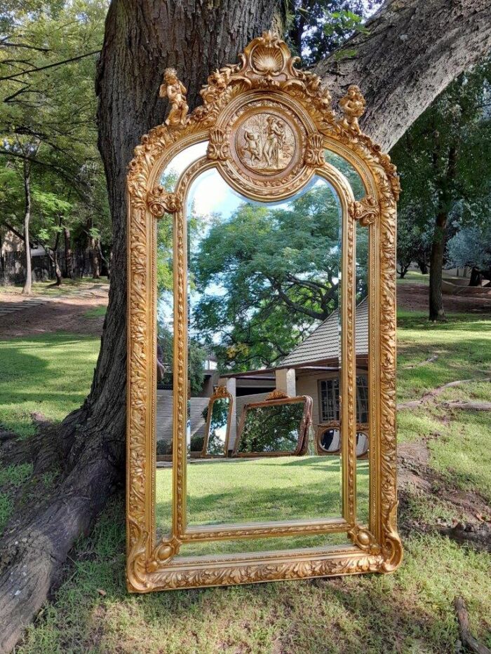 An Exceptional French Style Ornately Carved and Gilded Bevelled Mirror