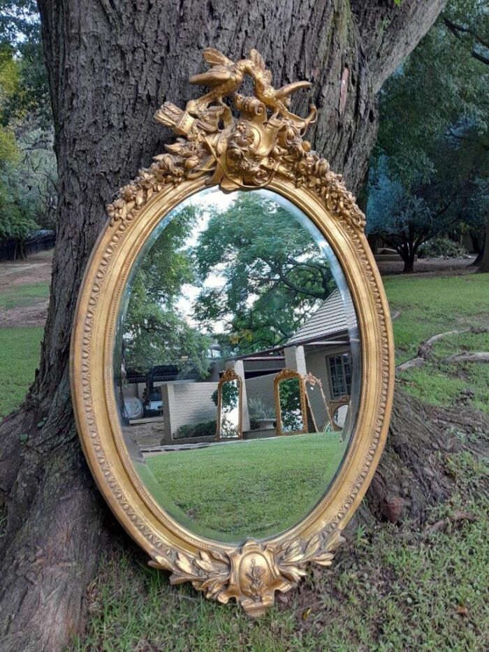 A French Style Ornately Carved and Gilded Bevelled Mirror