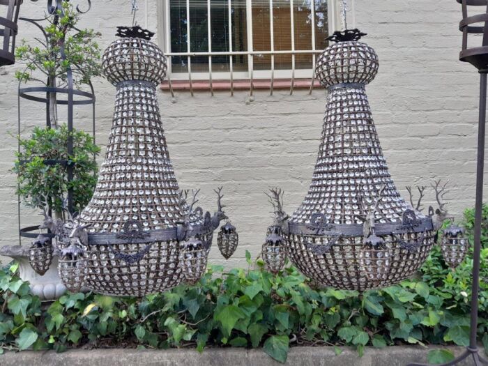 A Large Aged Pair of Monumental Empire French Style Chandeliers with Deer Head Figures