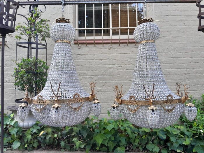 A Large Brass & Aged Pair of Monumental Empire French Style Chandeliers with Deer Head Figures