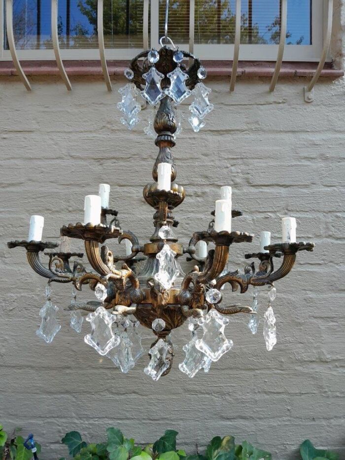 A 20th Century French Style Antique Brass and Crystal Twelve Light Chandelier