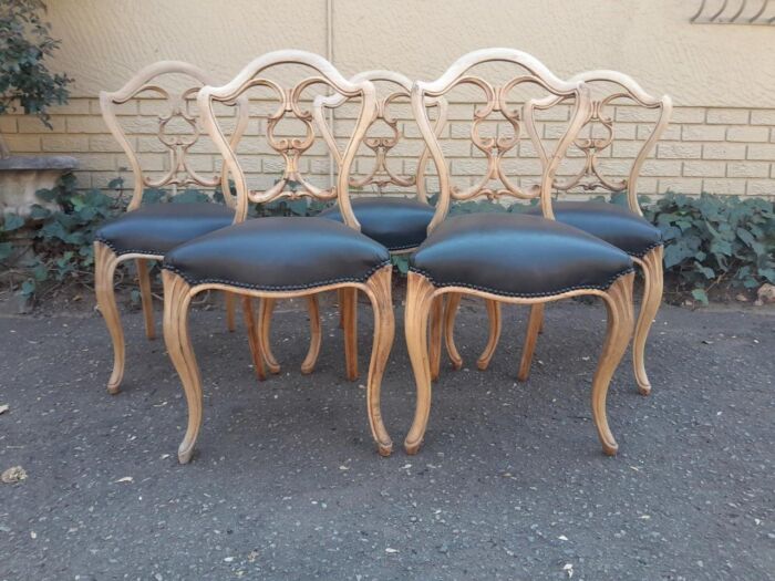 A 20th Century Set Of Five Carved Mahogany Dining Chairs In A Contemporary Bleached  /  Natural Finish Upholstered In Leather