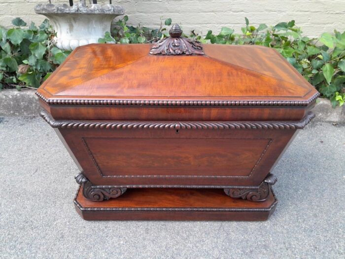 A 19th Century Flame Mahogany Wooden Carved  Cellarette on Carved Feet (Interior with Lead Lining for Wine Bottles and Ice)