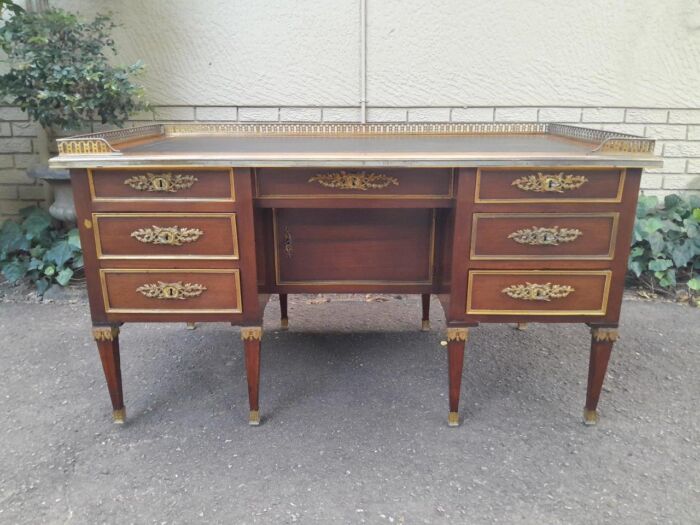 A 20th Century French Empire Style Mahogany Desk with Leather and Gilt Tooling Writing Surface and Brass Gallery