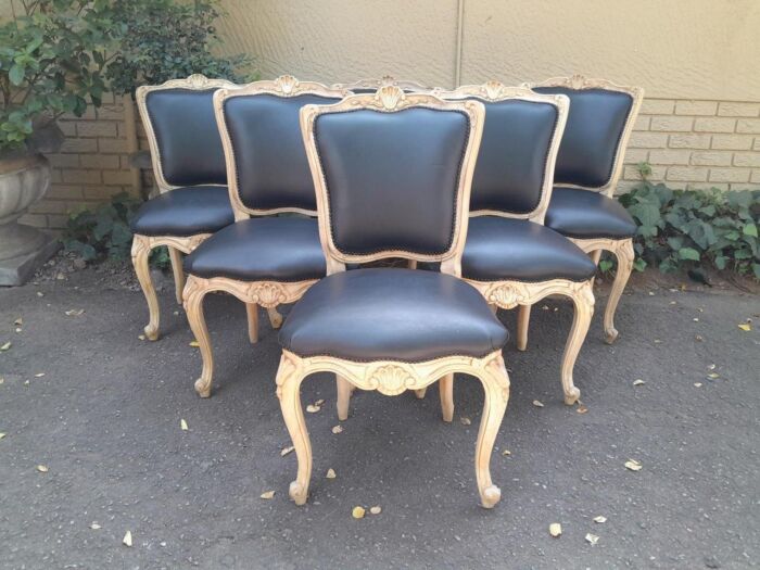 A 20th Set of Six French Style Dining Chairs in a Bleached Contemporary Finish and Upholstered in Leather