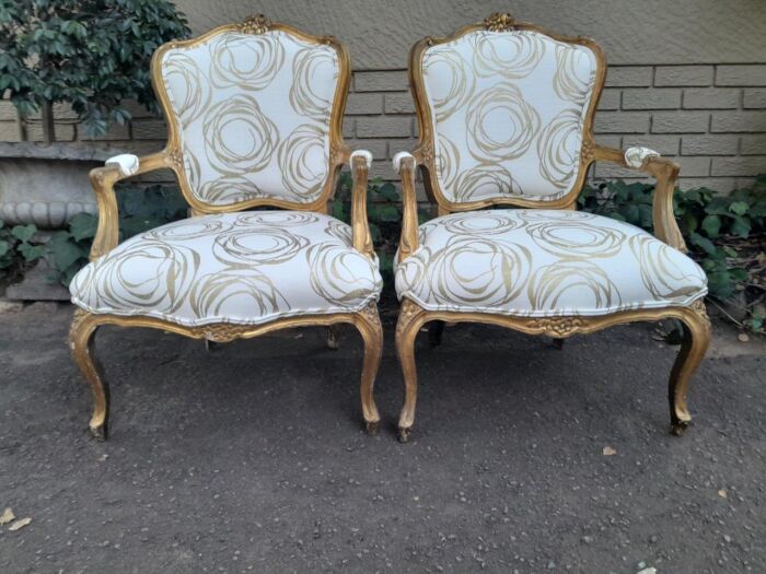 A 19th Century Pair of French Carved and Gilded Wooden Armchairs Upholstered in a Custom Made Fabric for The Crown Collection 