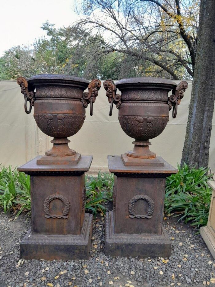 A 20TH Century Pair of French Cast Iron Urns / Planters on Plinths of Large Proportions