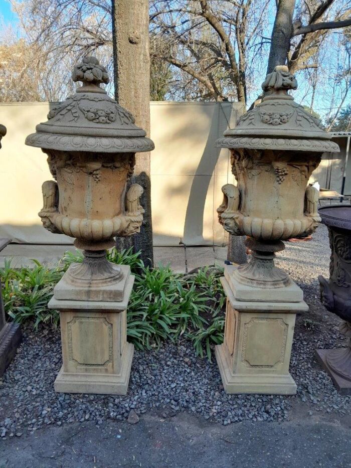 A 20th Century Pair of Large Decorative Concrete Urns with Lids on Plinths