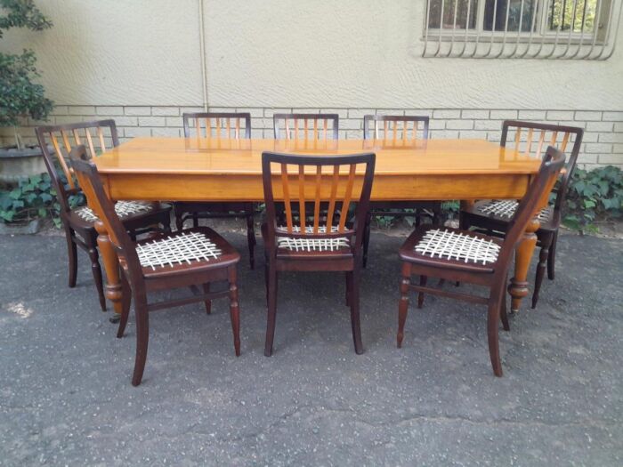 A Late 19thCentury  Early 20th Century Yellowwood Dining Table  with A 20th Century Set of Eight (8) Cape Stinkwood and Yellowwood Riempie Dining Chairs