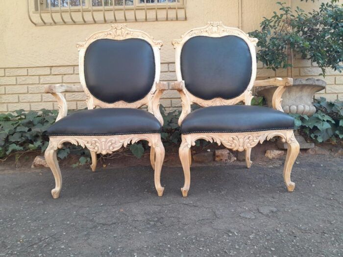 A 20th Century Pair Of French Style Carved Oak Armchairs In A Contemporary Bleached Finish And Upholstered In Leather