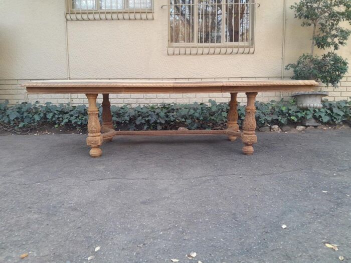 A 20th Century Wooden Dining / Refectory / Entrance Table With Carved Legs And Two Extending Leaves In A Contemporary Bleached  /  Natural Wood Finish