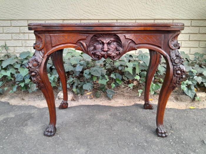 An Antique Jacobean Ornately Carved Oak Card Table with Black Baize