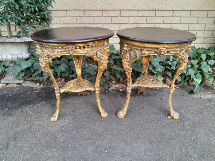 A 19th Century Pair of Original Victorian Britannia  Cast Iron Pub Tables with Teak Wooden Tops In a Contemporary Hand Gilded Finish