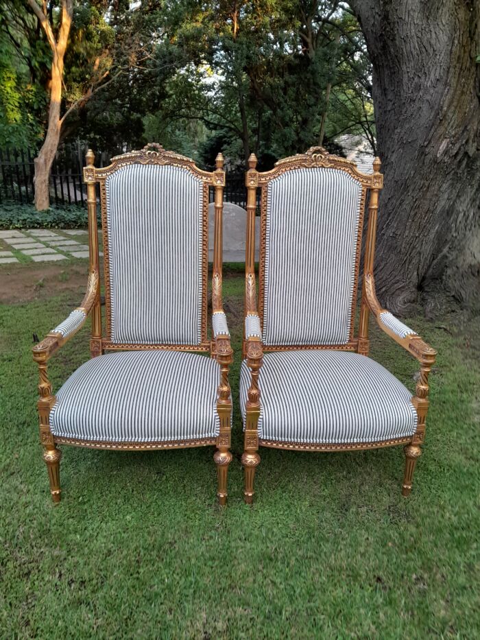 A Pair of French Rococo Style Ornately Carved Giltwood Arm Chairs Upholstered in a Contemporary Ticking Fabric - Image 3