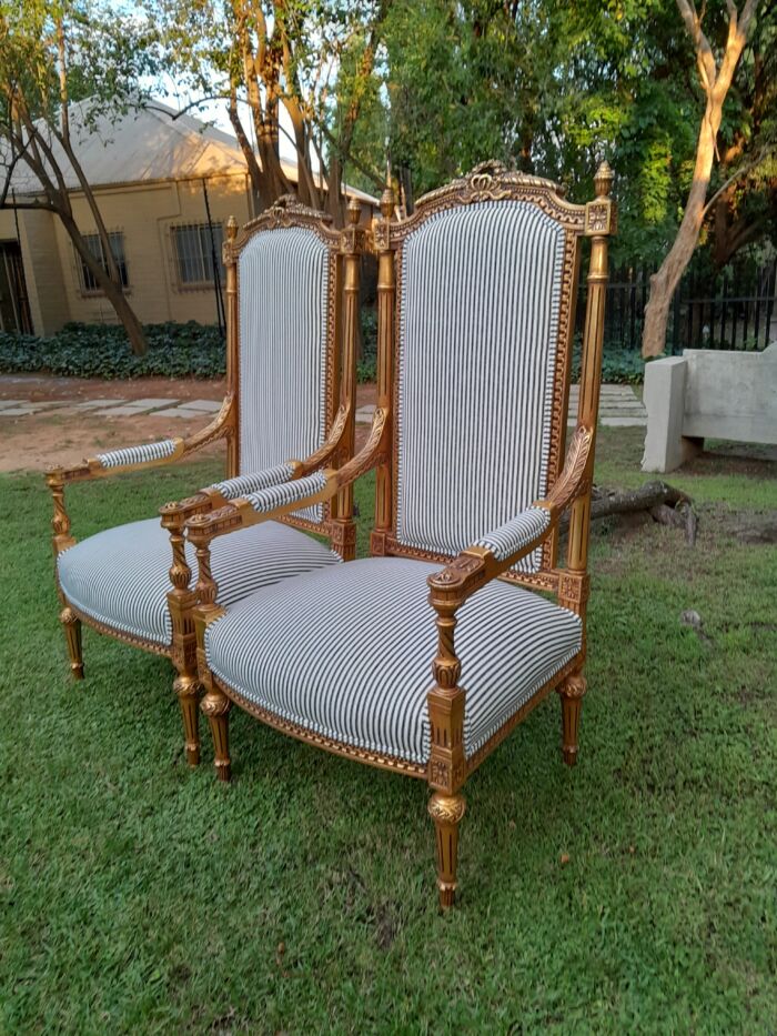 A Pair of French Rococo Style Ornately Carved Giltwood Arm Chairs Upholstered in a Contemporary Ticking Fabric - Image 4