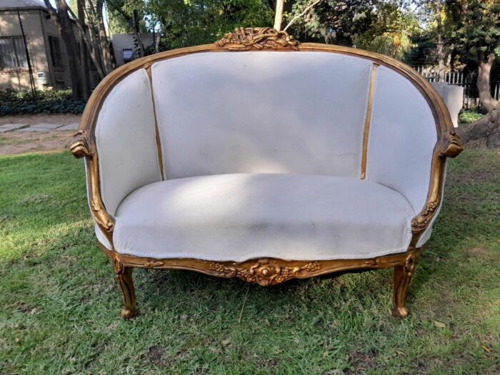 A French Style Ornately Carved and Gilded Bergere Chair