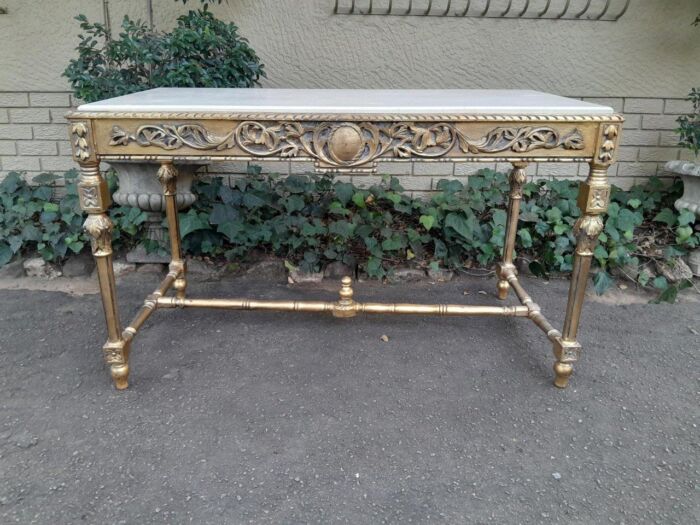 A 20th Century Ornately Carved and Hand-Gilded Console Table with Cream Marble Top