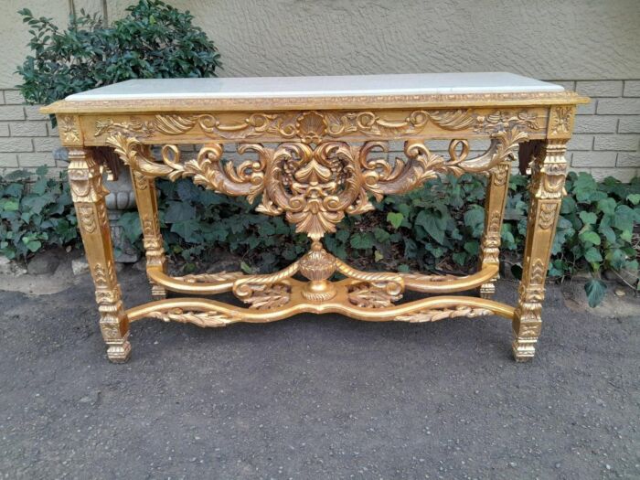 A 20th Century Ornately Carved and Hand-Gilded Console Table with Cream Marble Top