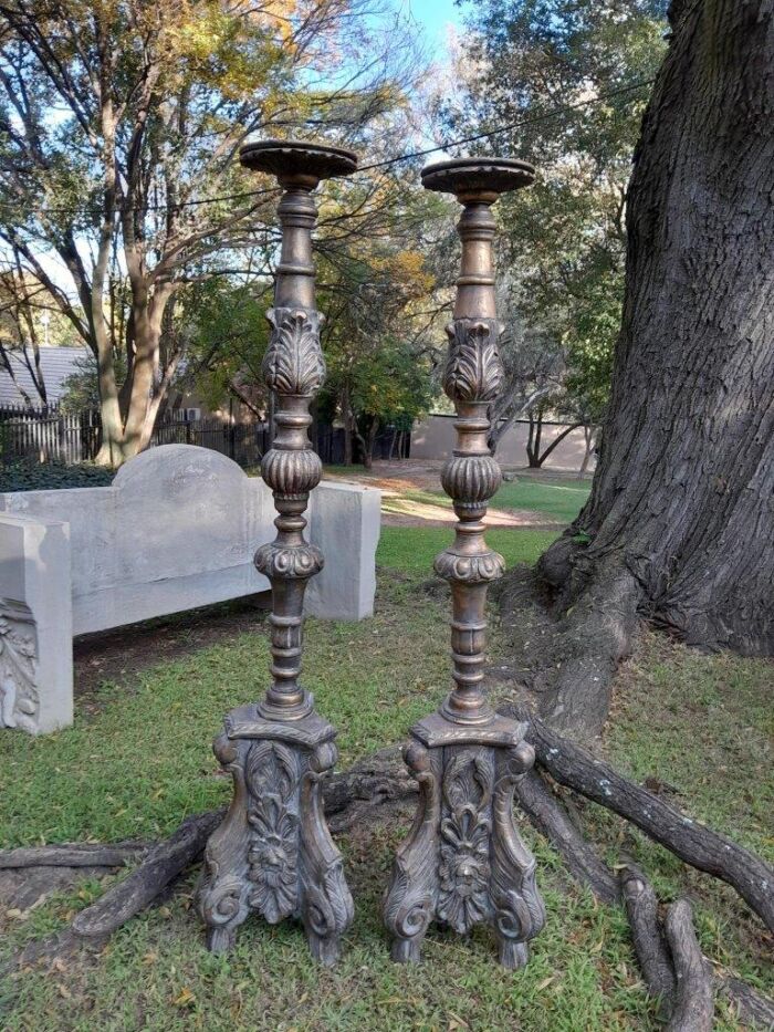 A Pair of French Style Carved and Gilded Floor or Table Candle Holders