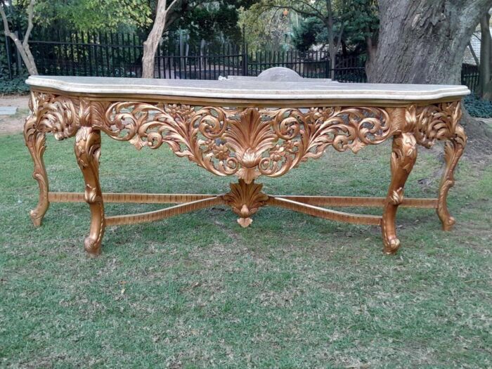 A 20th Century Ornately Carved and Hand-Gilded Console Table of Large Proportion with Cream Marble Top