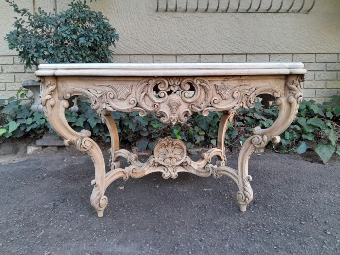 A 19th Century Ornately Carved Rococo Style Table with Marble Top in a Contemporary Bleached / Natural Finish