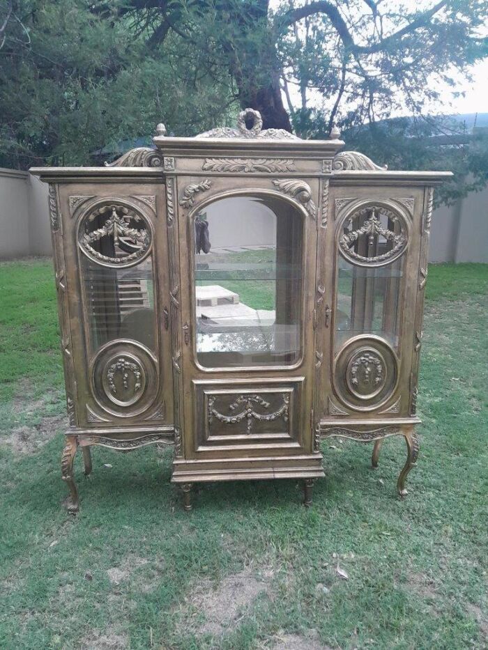 A 20th Century French Style Three Division and Large Ornately Carved and Hand-Gilded Display Cabinet