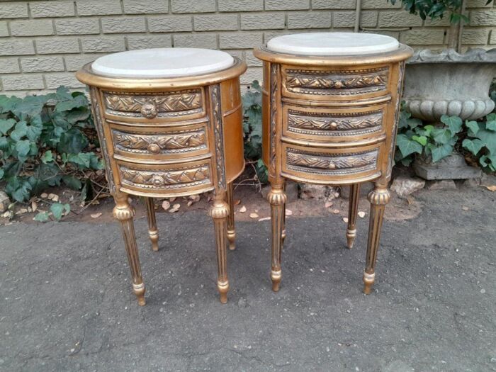 A Pair Of French Style Hand-Gilded Round Pedestals / Side Tables With Drawers And Cream Marble Tops