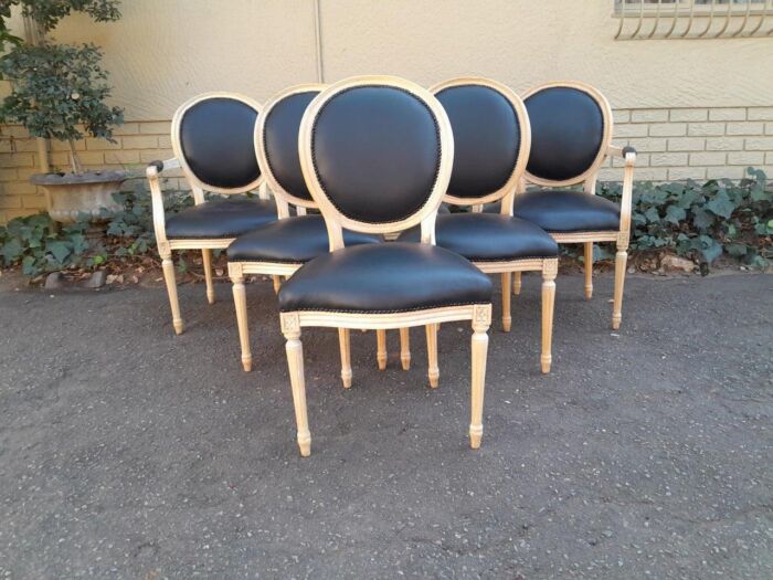 A 20th Century French Style Set of Six (6) Chairs Comprising a Pair of Carvers / Arm Chairs and Four Dining Chairs in a Contemporary Bleached Finish and Upholstered in Leather 