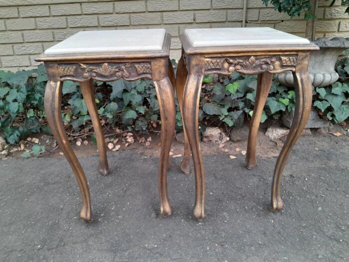 A 20TH Century French Style Pair Of Carved And Gilded Side Tables With Marble Tops