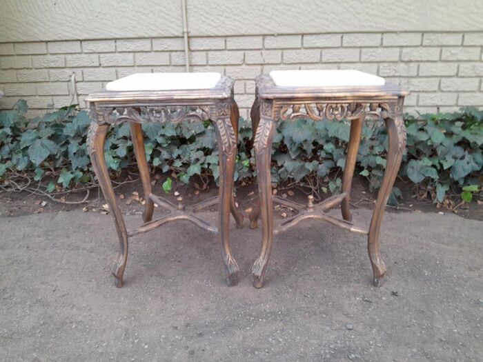 A 20TH Century French Style Pair Of Carved And Gilded Side Tables With Marble Tops