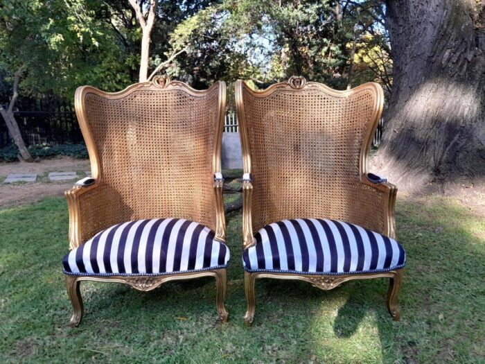 A Pair of 20th Century French Style Gilt Wood Arm Chairs with Rattan Back