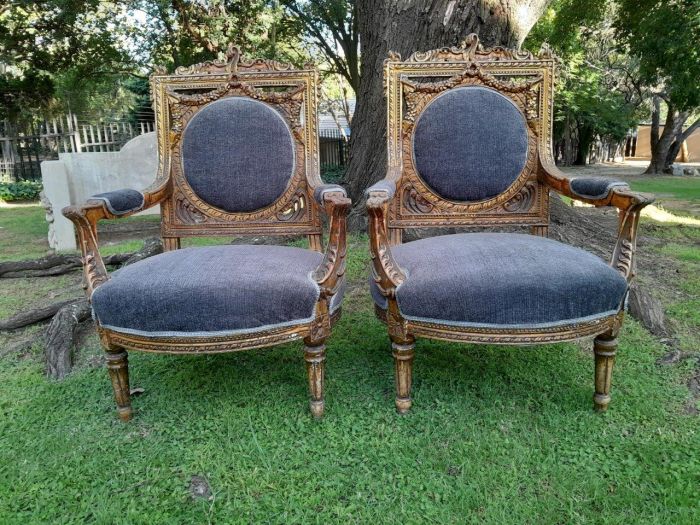 A Pair Of 20th Century French Style Ornately Carved Gilt Wood Arm Chairs