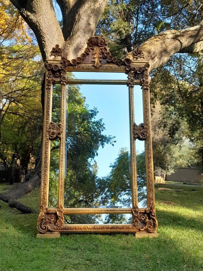 A French Rococo Style Ornately Carved & Gilded Bevelled Mirror