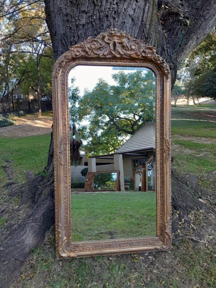 A French Rococo Style Ornately Carved & Gilded Bevelled Mirror