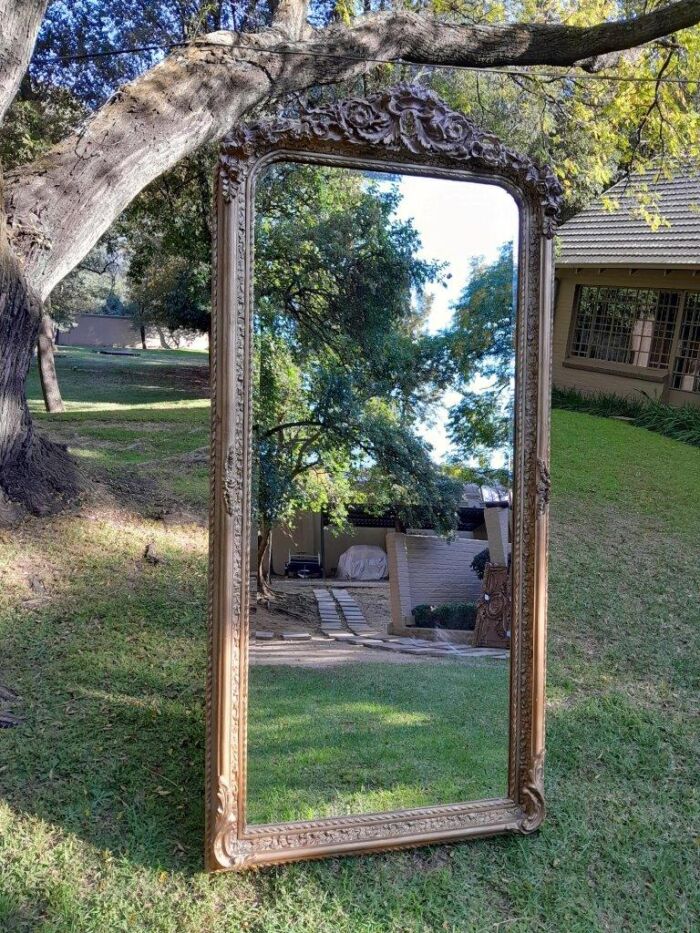 A French Rococo Style Ornately Carved & Gilded Bevelled Mirror