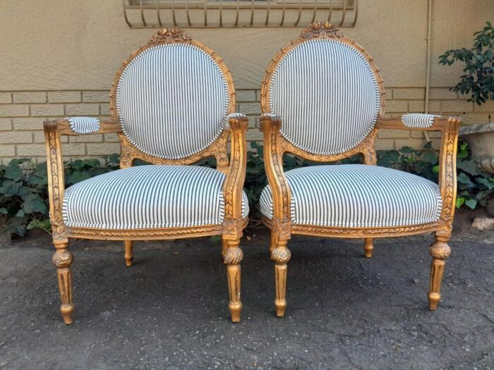 A 20TH Century French Style Pair Of Ornately Carved Giltwood Armchairs