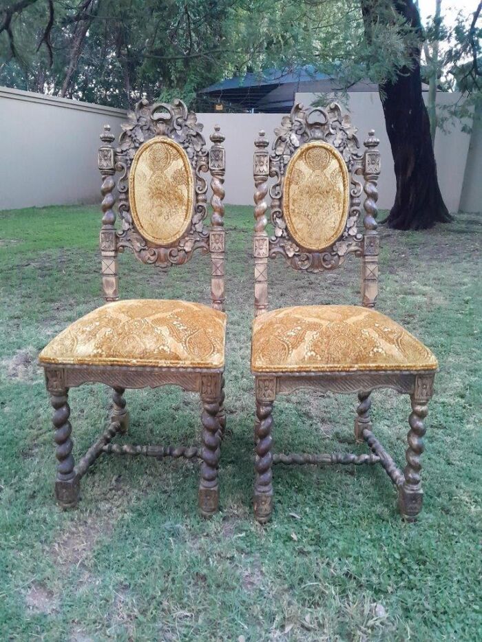 A Pair of 19th Century French Ornately Carved and Gilded Chairs