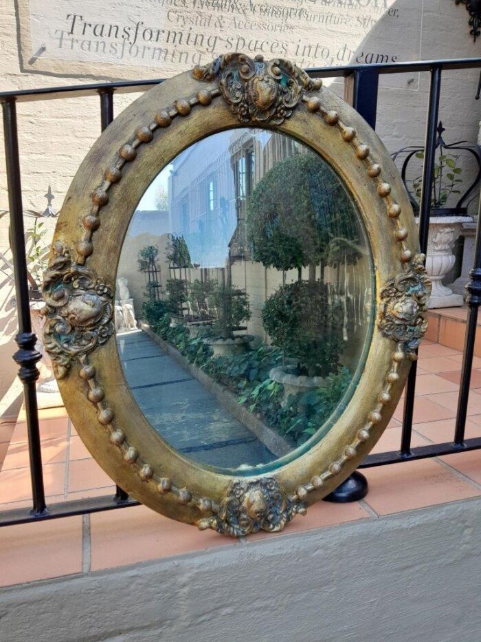 A 20TH Century Gilt Oval Mirror With Convex Mirror