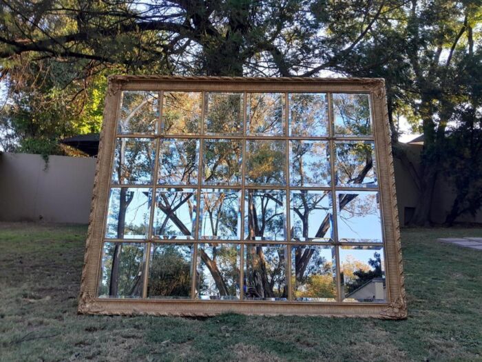 A French Style Heavily Carved and Gilded Framed Mirror with Bevelled Mirror Panes of Large Proportions