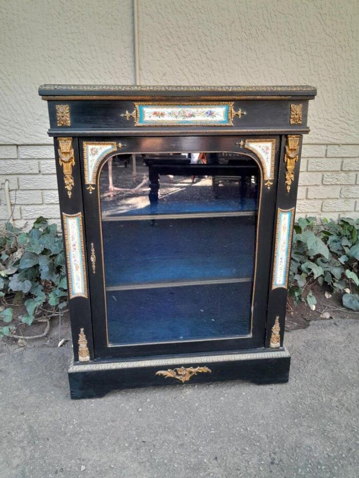 A 19th Century French Ebonised Pier Cabinet And Ormolu Mounts And Porcelain